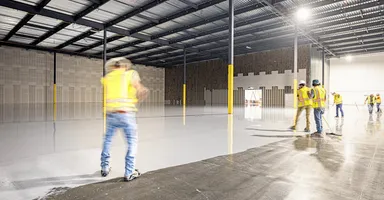 Industrial warehouse scene with bright yellow safety gear